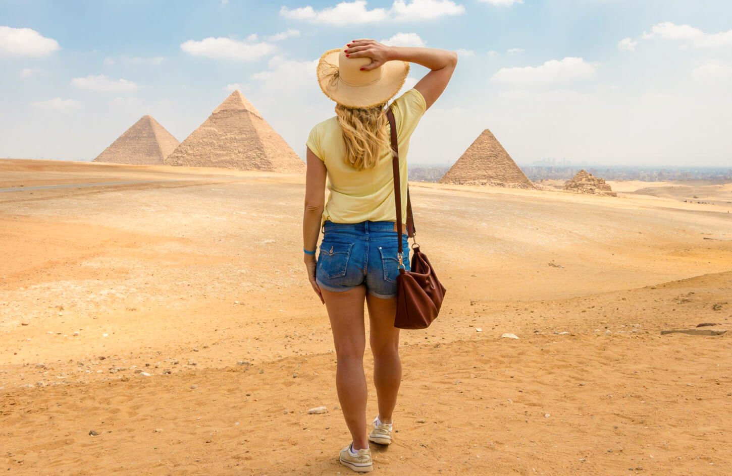 A-great-shot-of-a-solo-female-traveler-in-front-of-the-pyramids